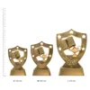 Academic Gold Shield trophies next to ruler Academic Gold Shield trophies next to ruler