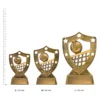 Volleyball Gold Shield trophies next to ruler Volleyball Gold Shield trophies next to ruler